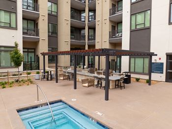 Designer pool with courtyard, cabanas, fire features & an outdoor kitchen area